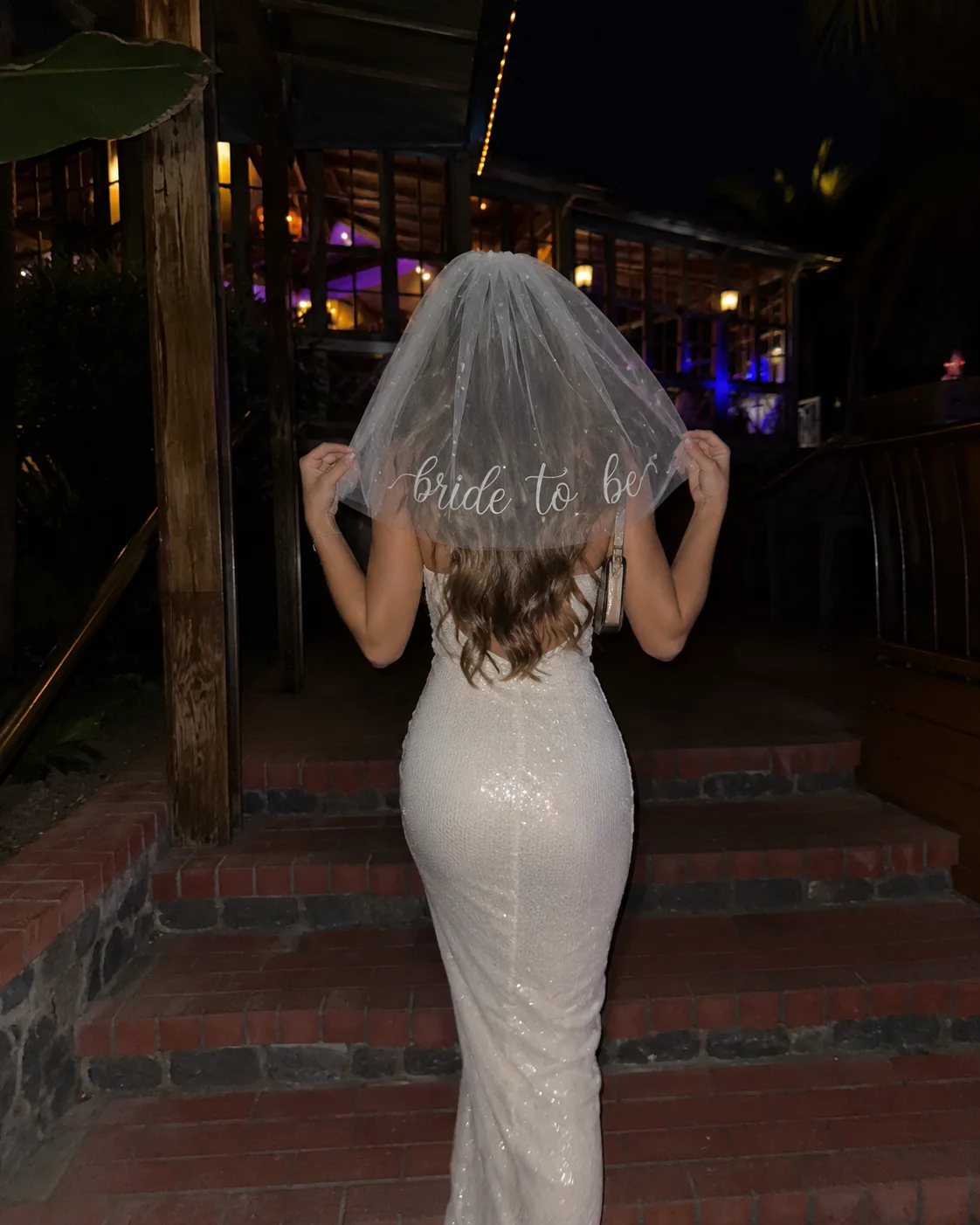 A bride from behind in a bride-to-be veil