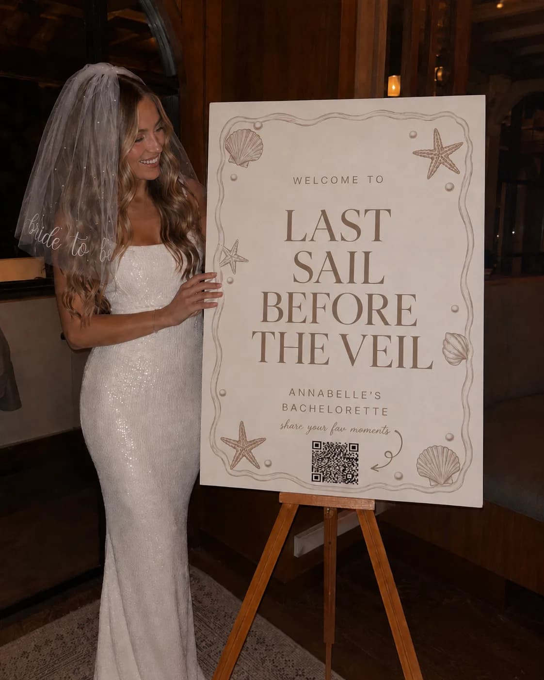 A bride beside her Eventi QR welcome sign